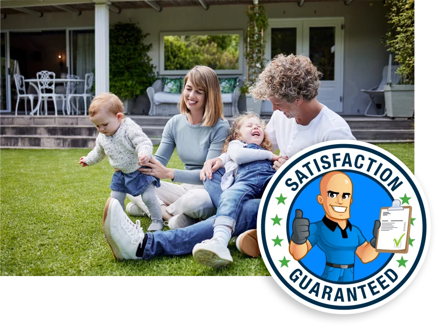 family sitting in green healthy grass playing