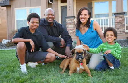 family outside playing with dog