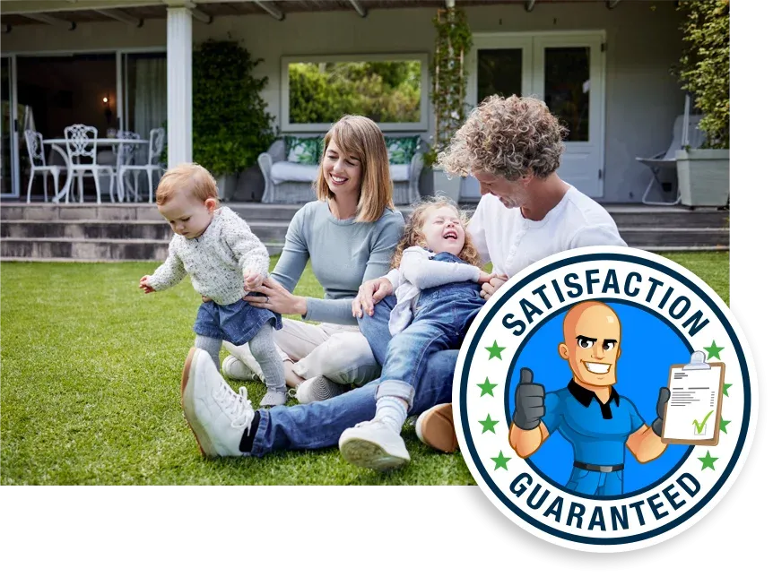 family sitting in green healthy grass playing