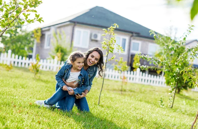 mother and daughter playing in back yard